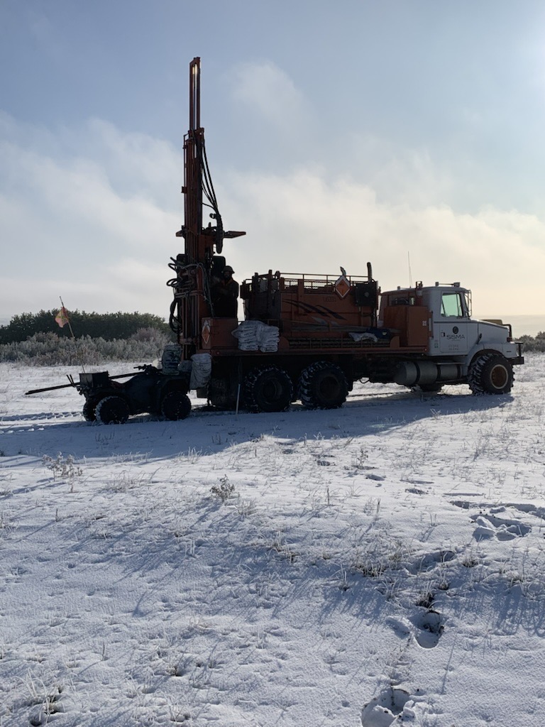 Heli-portable shot hole drill rig drilling a source hole in remote forest