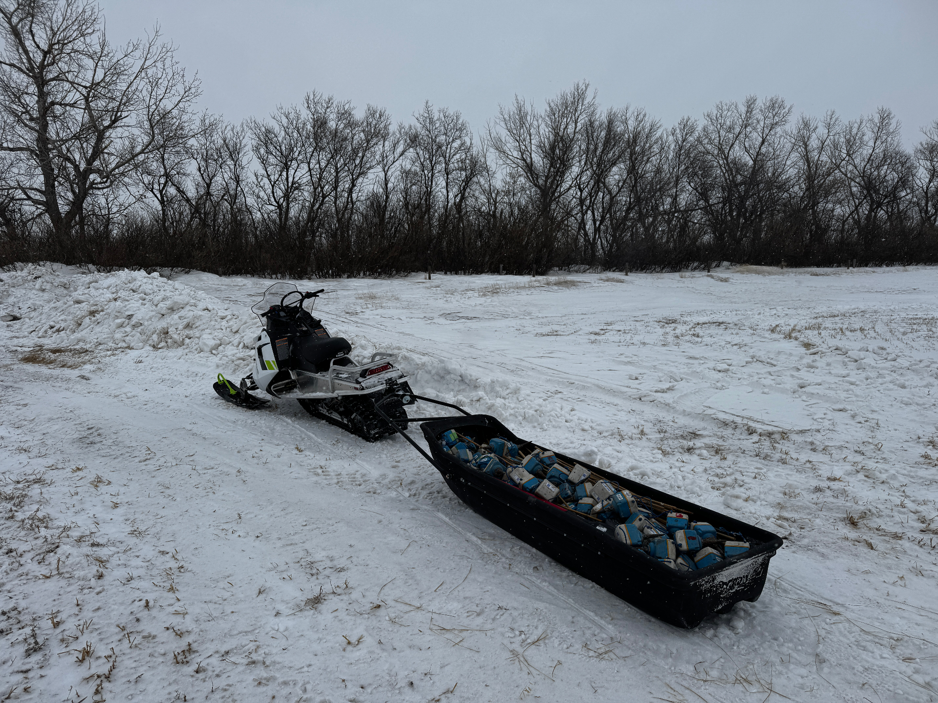 Tracked pickup sled recovering geophones from a seismic spread
